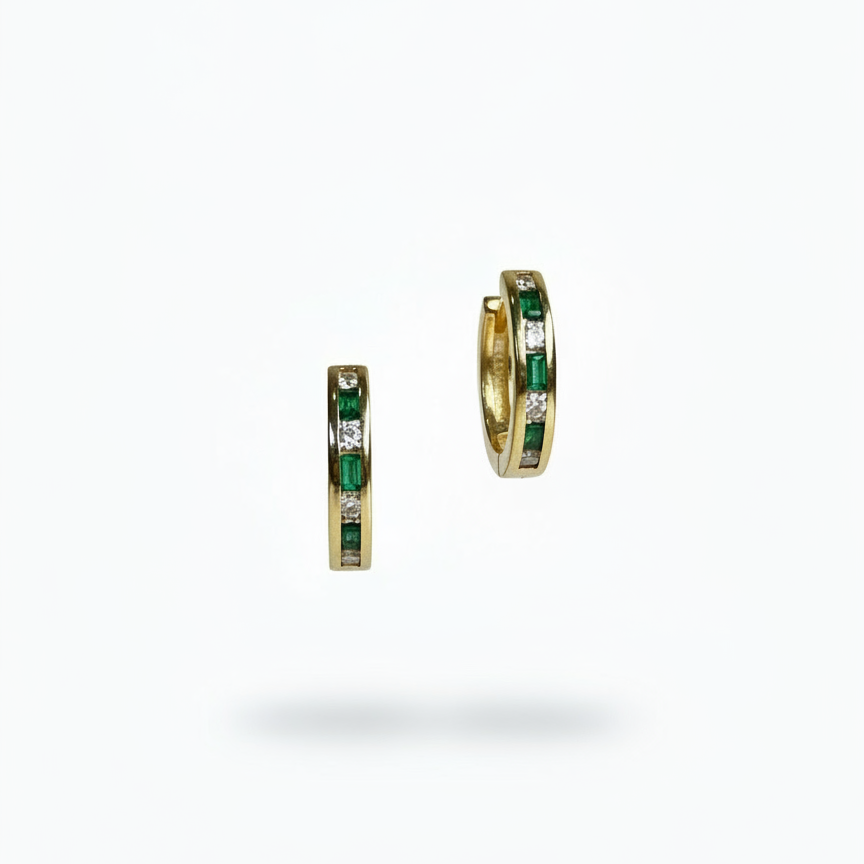 Gold hoop earrings with green gemstones on a white background