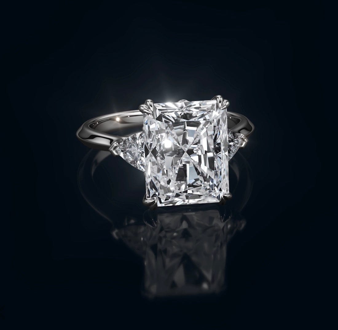 Diamond ring with a rectangular cut gemstone on a black background