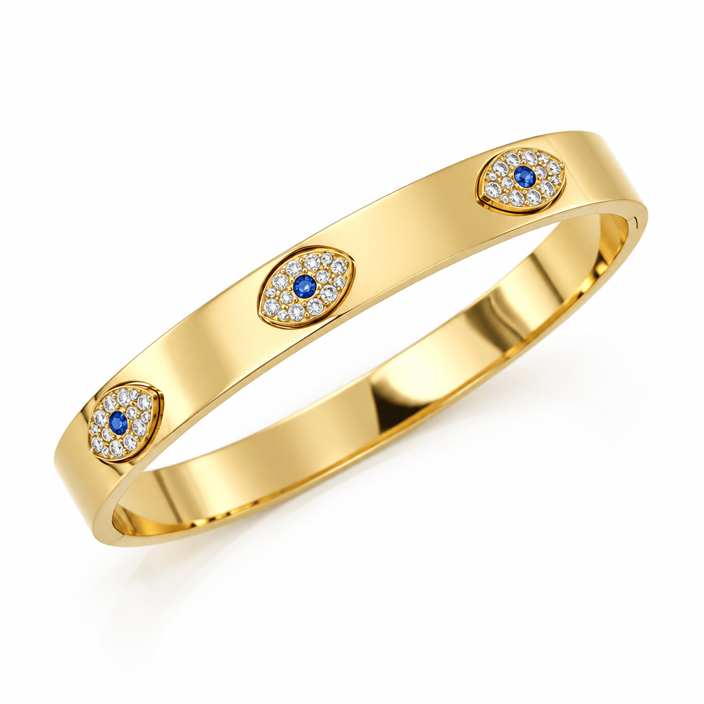 A polished yellow gold bangle bracelet featuring three oval evil eye motifs set with small clear pavé stones and blue center stones, shown on a clean white background.