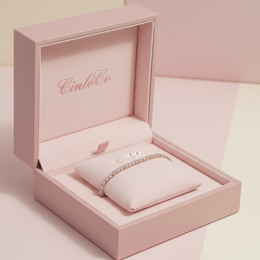 Pink jewelry box with a bracelet inside, featuring the brand 'Cinco Co'.