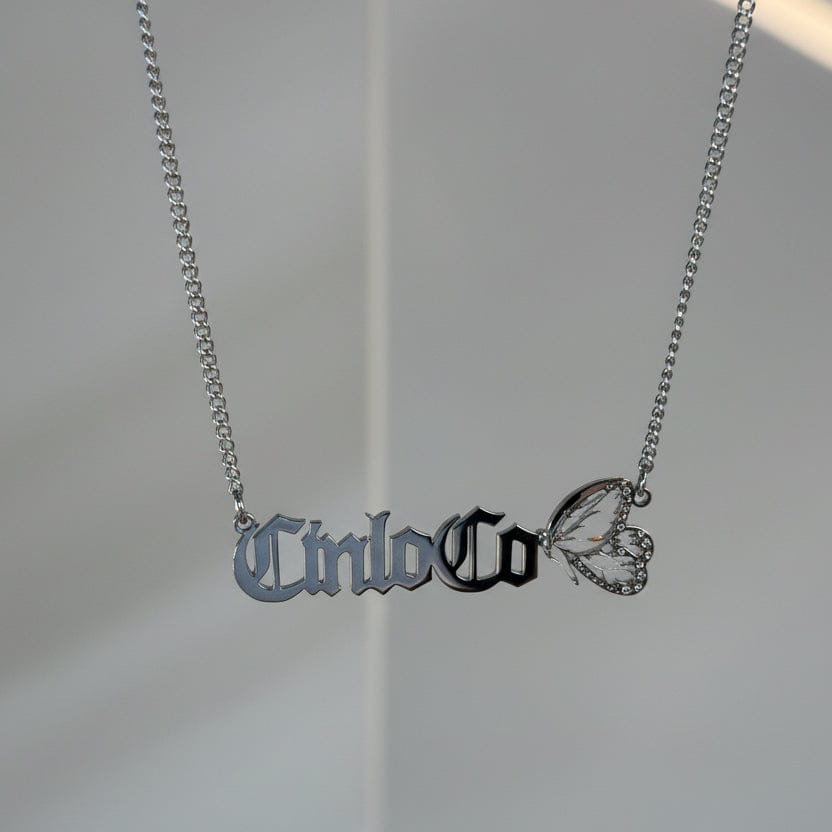 Necklace with 'Cinco Co' pendant on a plain background