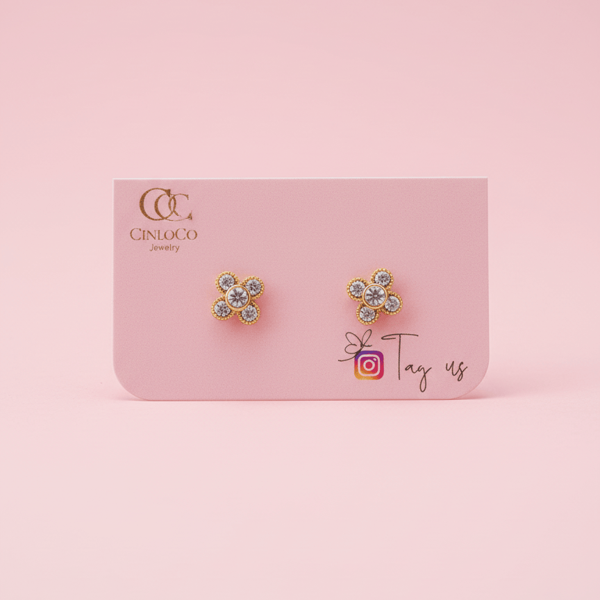 Pair of flower-shaped earrings on a pink card with 'Cintuco' branding.