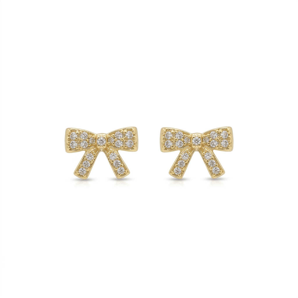Gold bow earrings with clear pave stones on a white background