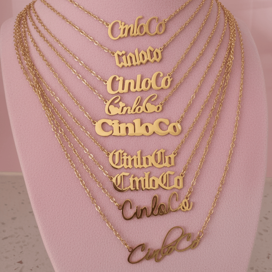 Gold necklaces with customizable name plate necklace branding on a mannequin bust.