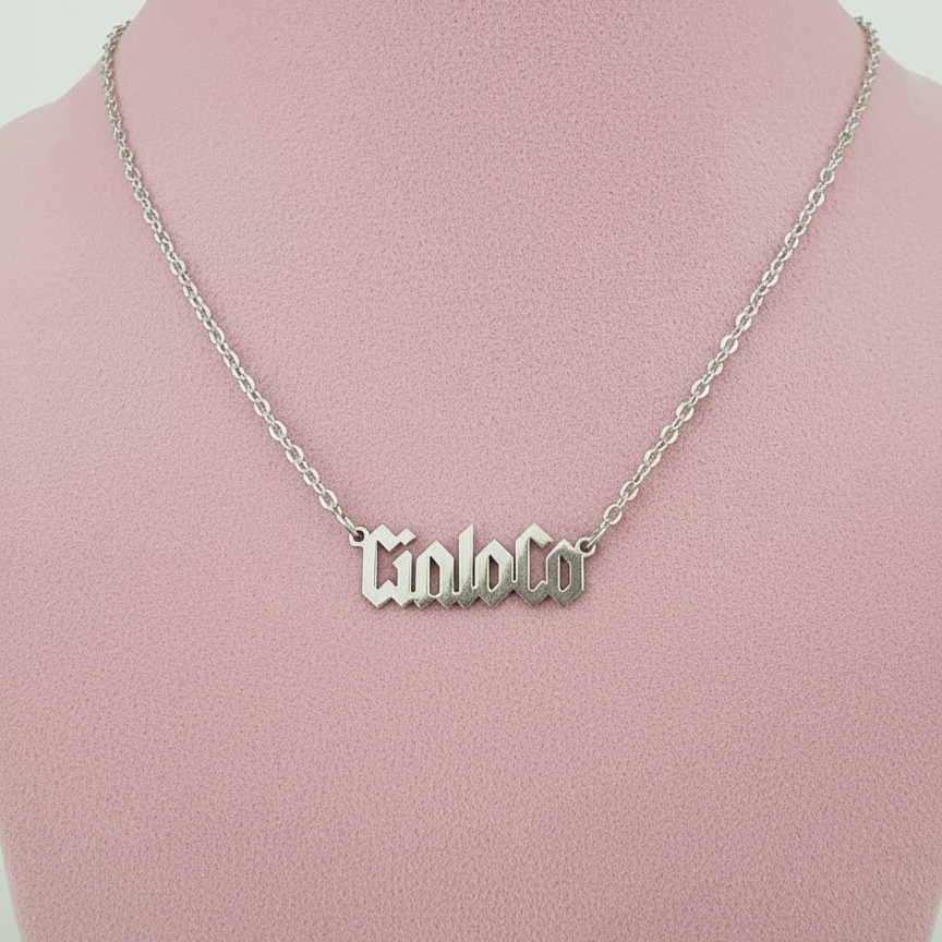 Silver necklace with Customizable name plate pendant on a pink mannequin