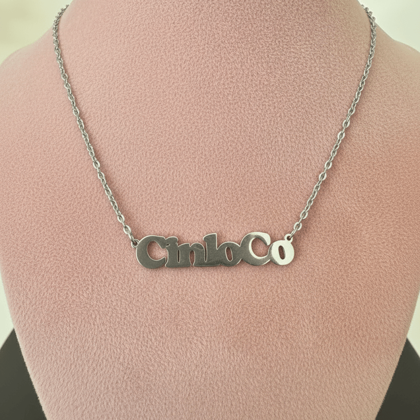 Silver necklace with a customizable name plate pendant on a mannequin bust.