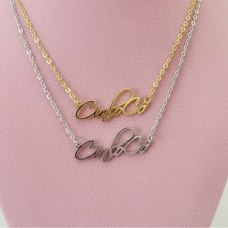 Two necklaces with name plate script on a black stand