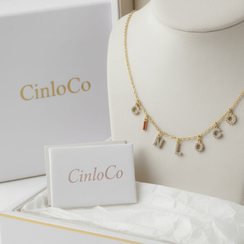 Gold necklace with letter charms on a white background