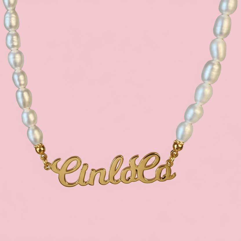 Necklace with 'CinloCo' name pendant on a pink background