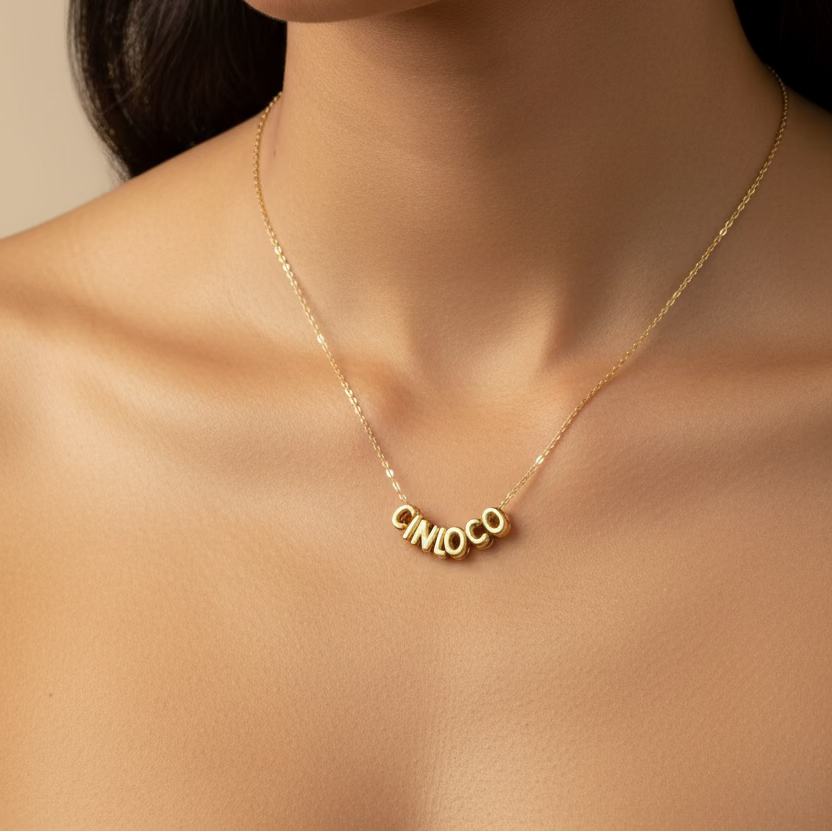 Gold necklace with circular pendants on a mannequin bust.