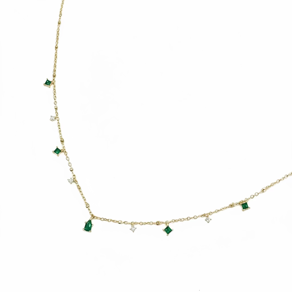 Necklace with green gemstones on a light gray background