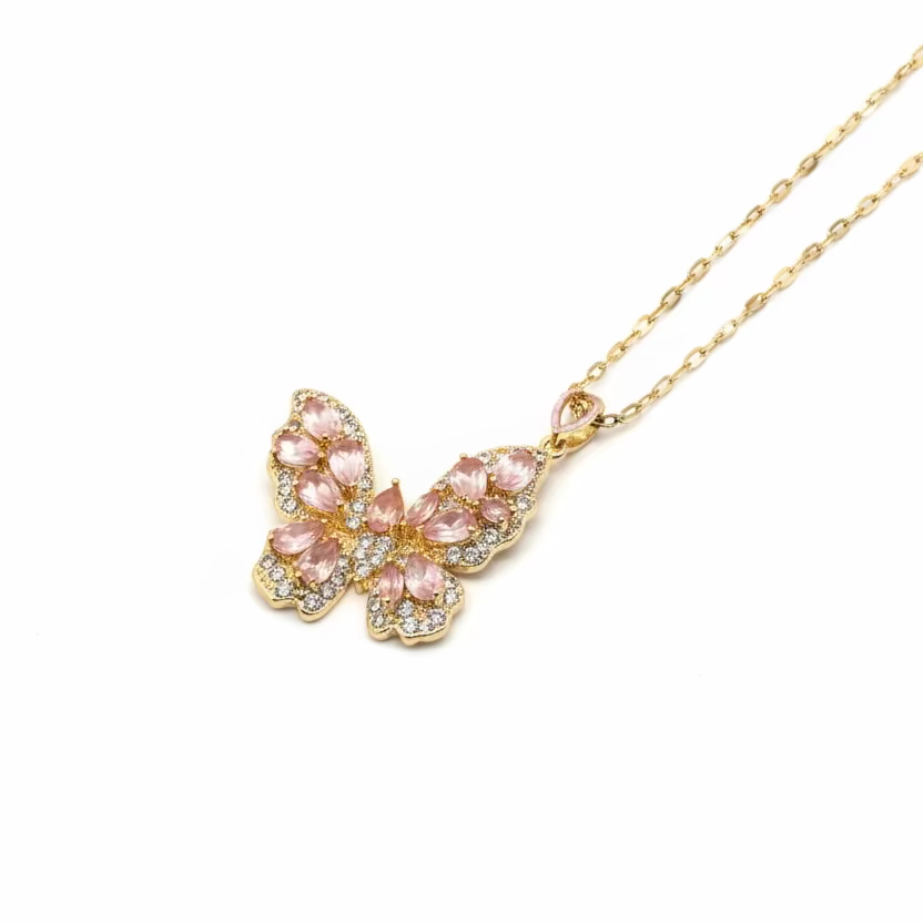 Butterfly-shaped pendant necklace on a pink box