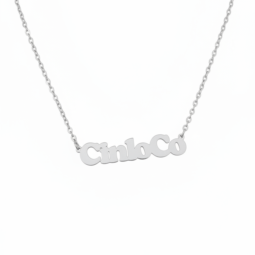 Silver necklace with 'CincoCo' pendant on a white background