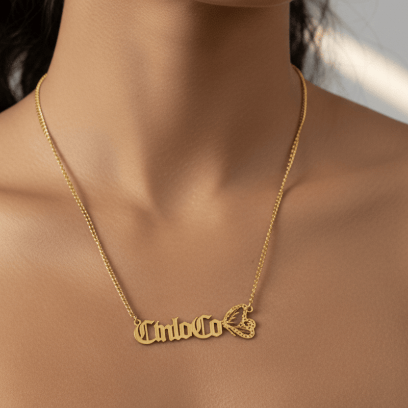 Gold necklace with 'Cinco Co' pendant on a person's neck