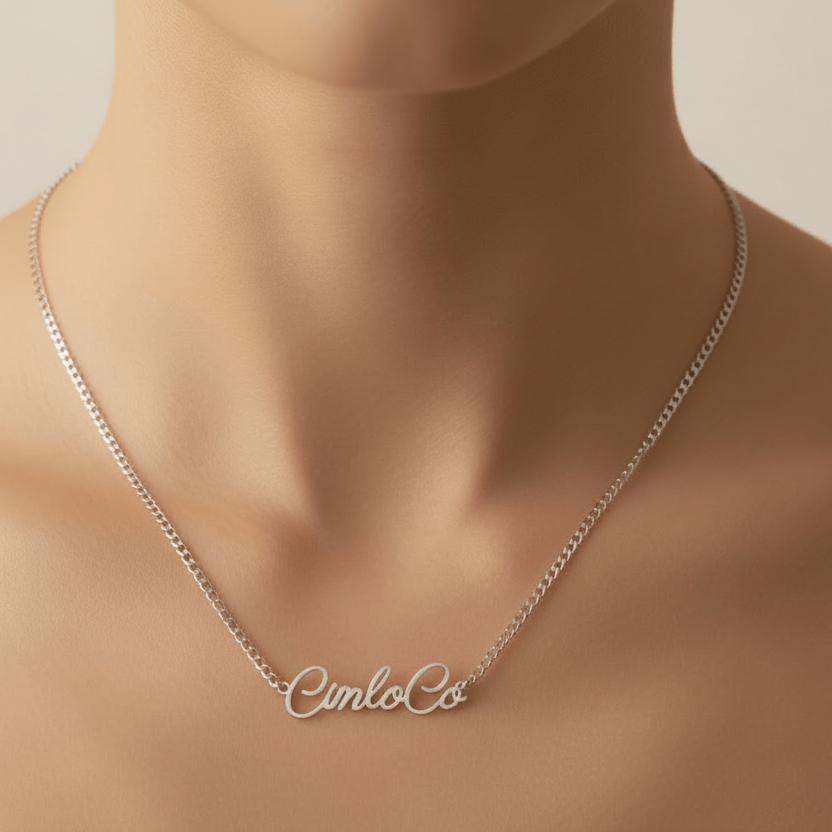 Silver necklace with 'Cinco Co' pendant on a mannequin neck against a neutral background