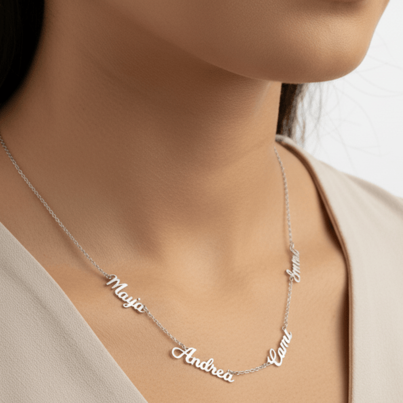 Silver name necklace on a person wearing a beige top