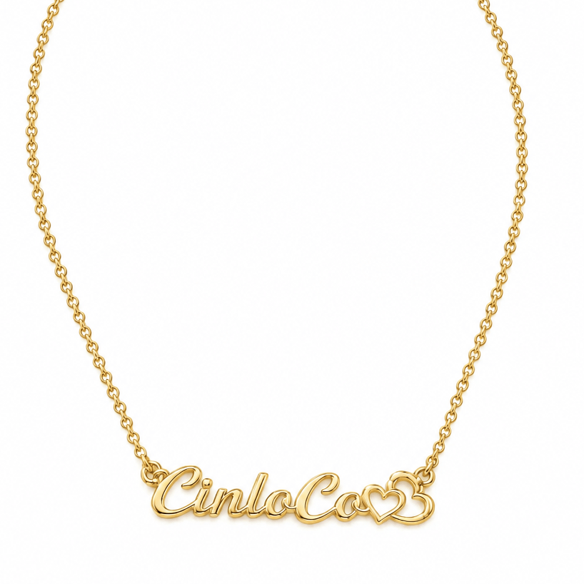 A gold chain necklace with a personalized script nameplate reading 'Cinco Co' and a small heart, shown on a plain white background.