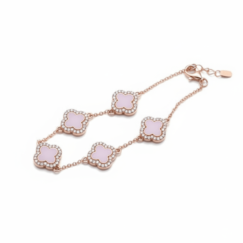 A rose gold chain bracelet featuring five alternating clover-shaped links with pale pink enamel centers and delicate crystal borders, displayed on a clean white background.