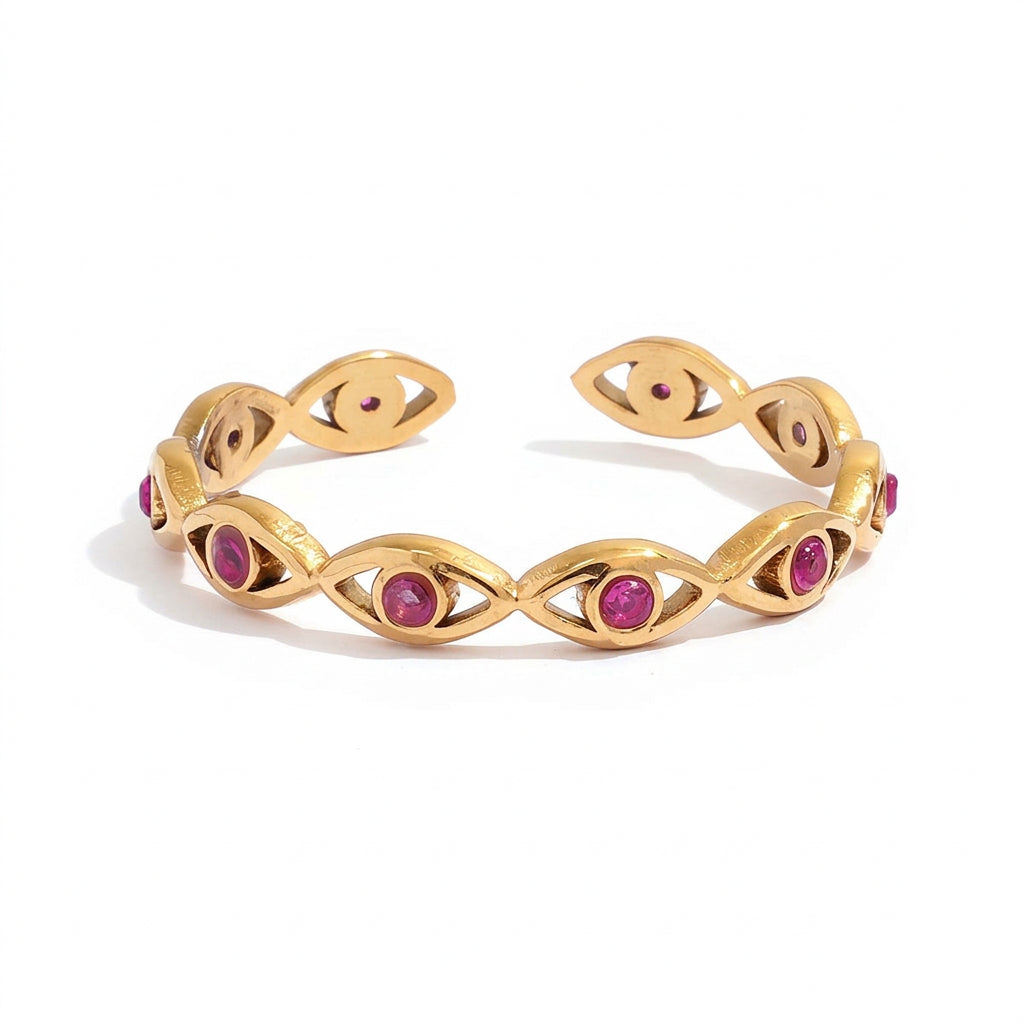 Gold adjustable cuff bracelet with oval eye motifs and pink gemstone accents, shown with measurement callouts and weight text on a white background.