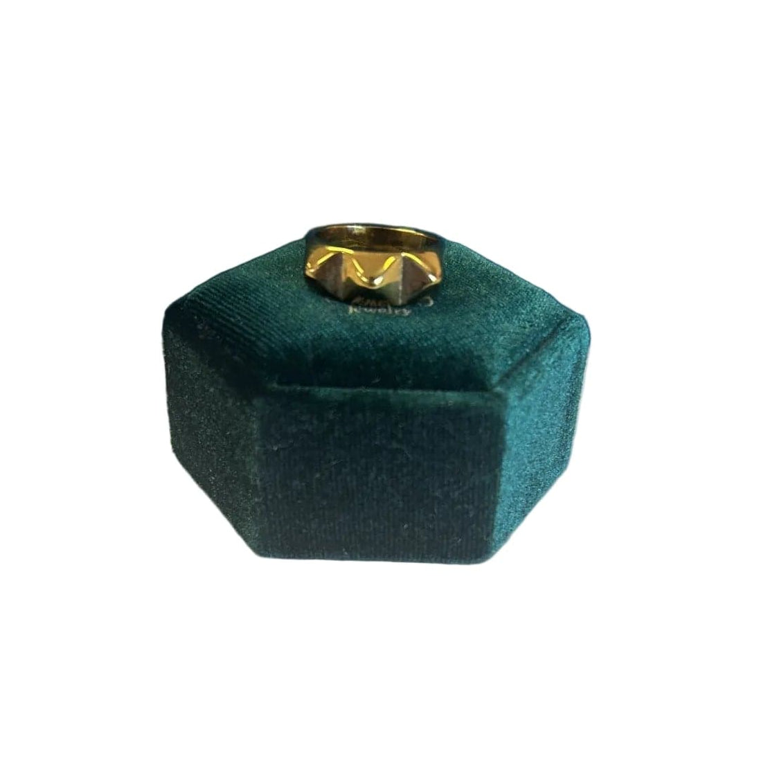 Hexagonal green velvet jewelry box with a gold ring on a white background