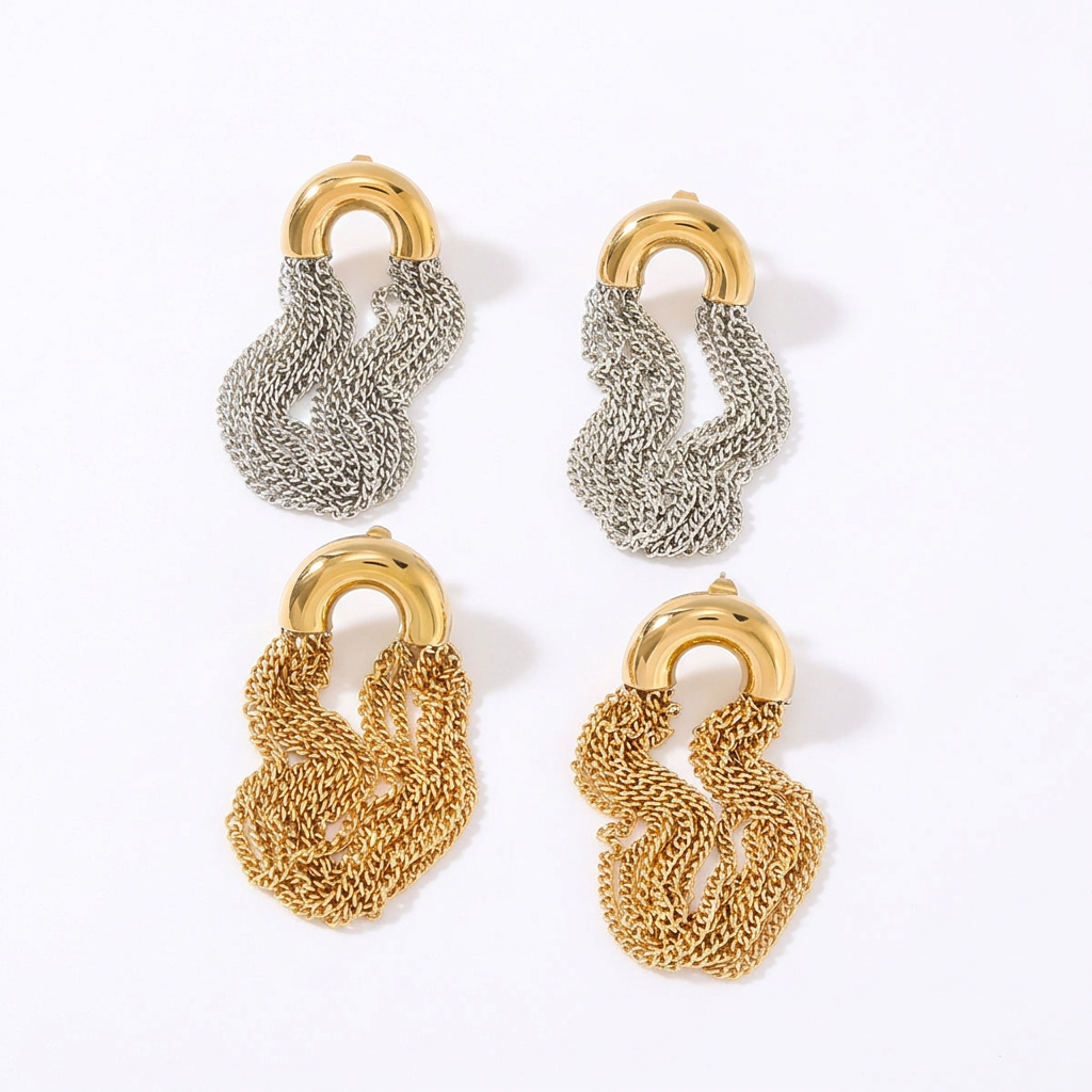 Gold and silver dangling chain earrings on a white background