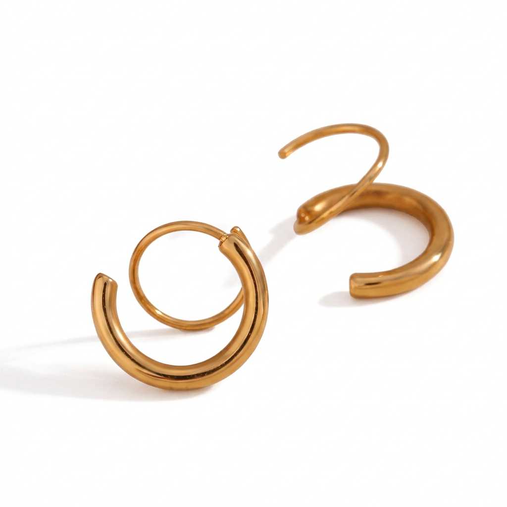 Gold spiral hoop earrings on a white background