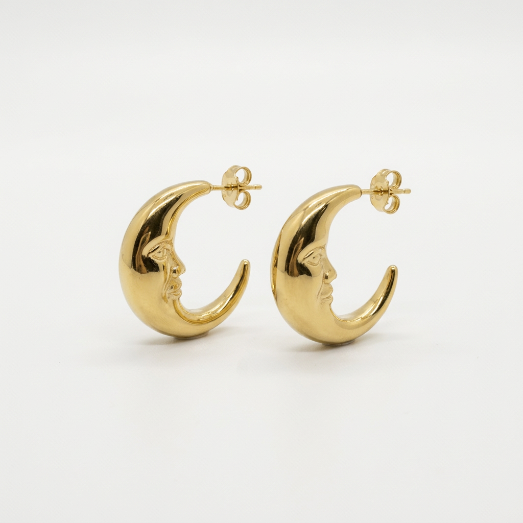 Gold crescent moon stud earrings on a white background