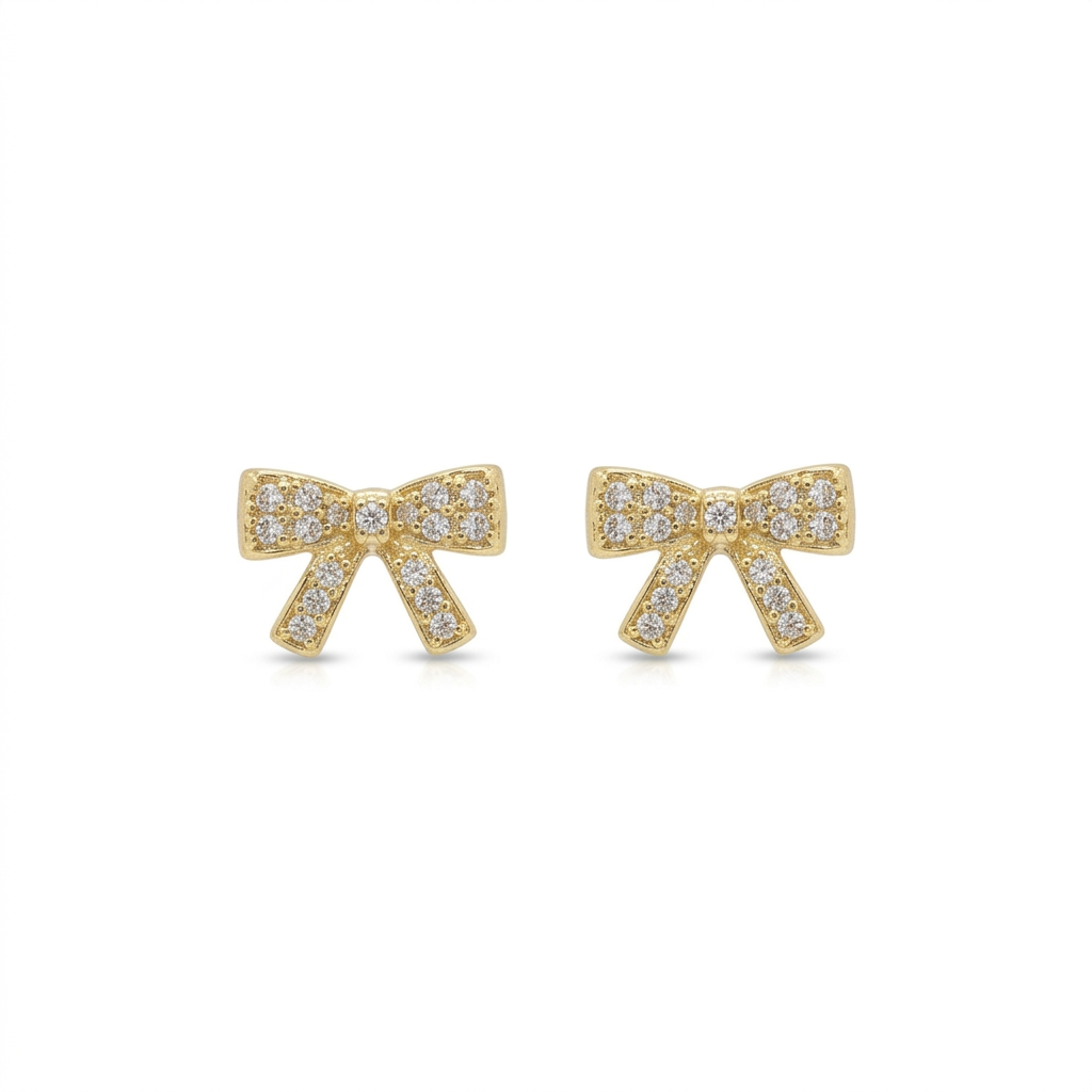 Gold bow earrings with clear pave stones on a white background