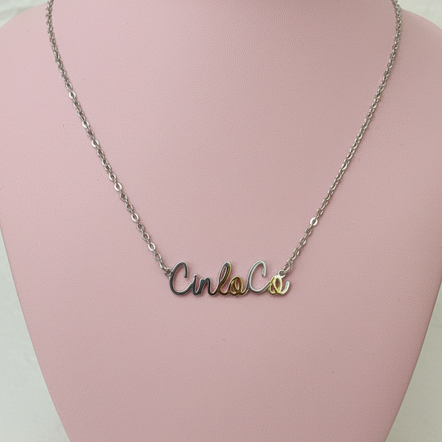Necklace with silver customizable name plate pendant on a pink mannequin bust.