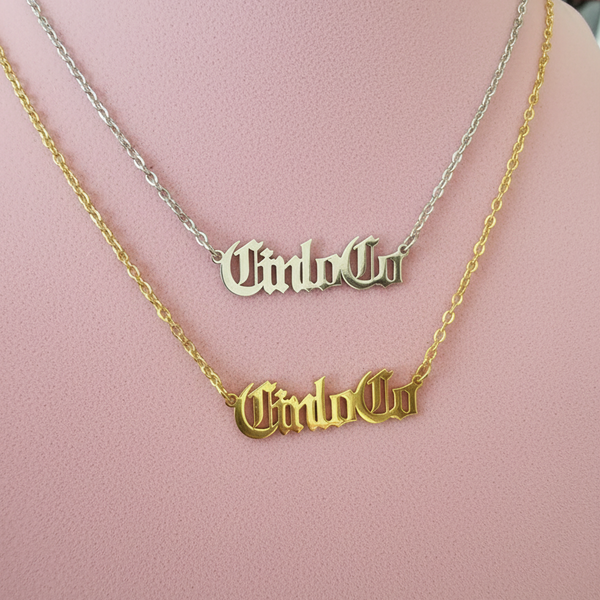 Two necklaces with CUSTOM NAME PLATE pendants on a mannequin.
