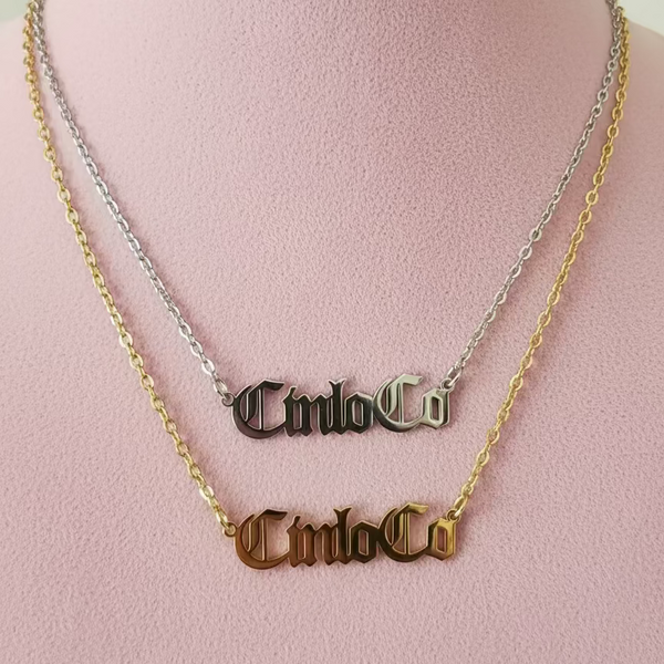 GOLD AND SILVER NECKLACE CUSTOM NAME PLATE on a pink background