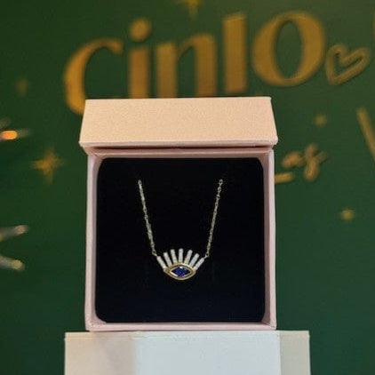 10K WHITE GOLD EVIL EYE Necklace in a box with a festive green background