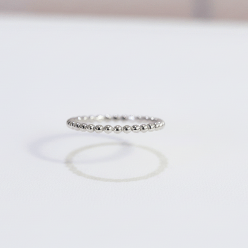 Two silver rings on a light gray background