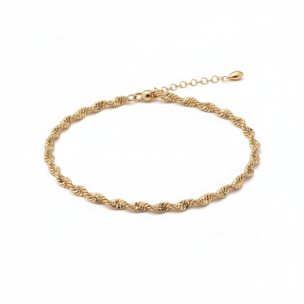Gold bracelet on a wrist with a neutral background