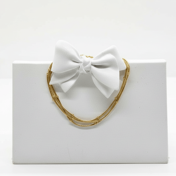 White bow with gold frame on a white background