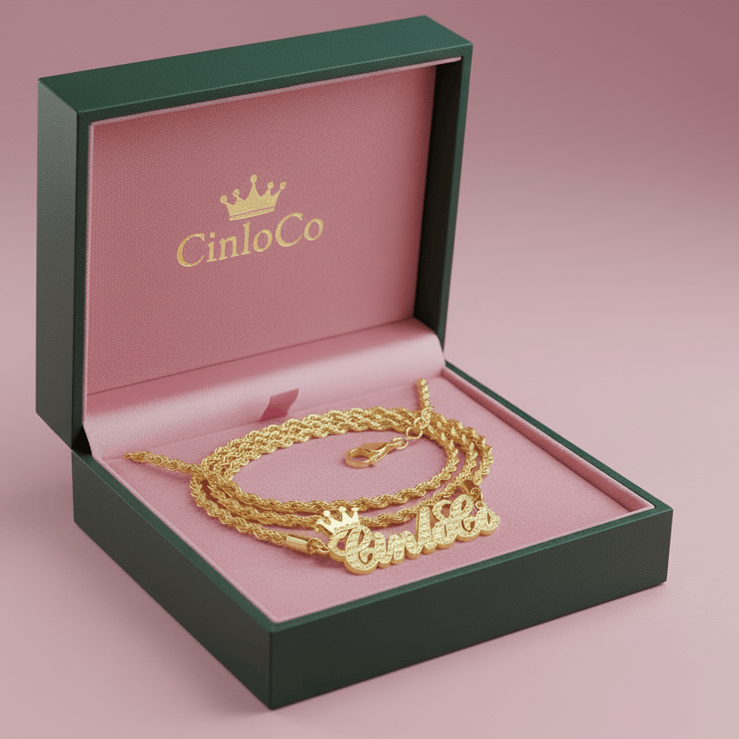 Gold necklaces in a green and pink box with CinloCo branding