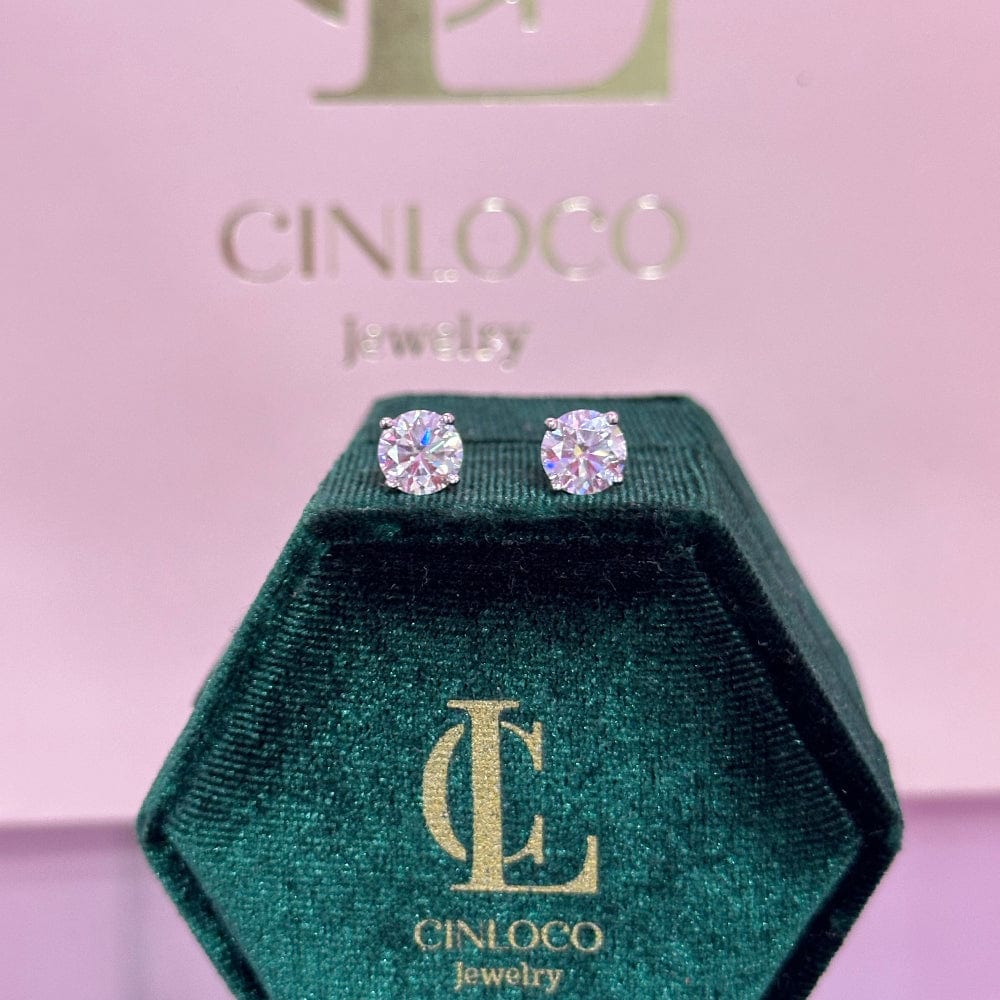 Cinloco jewelry box with diamond earrings on a pink background