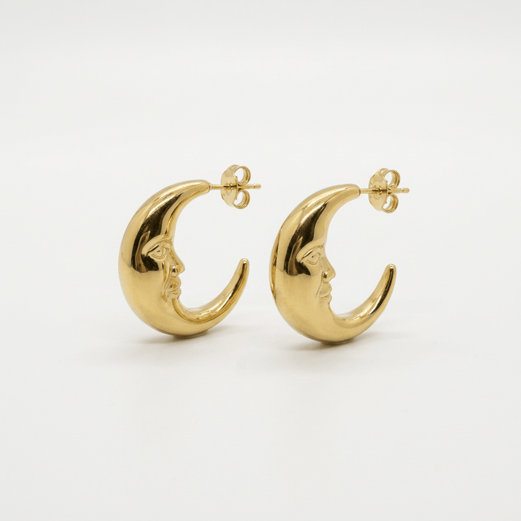 Gold crescent moon stud earrings on a white background