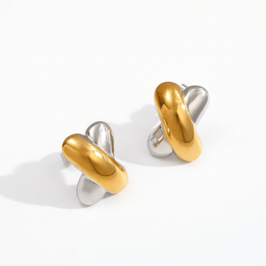 Gold and silver X-shaped earrings on a white background
