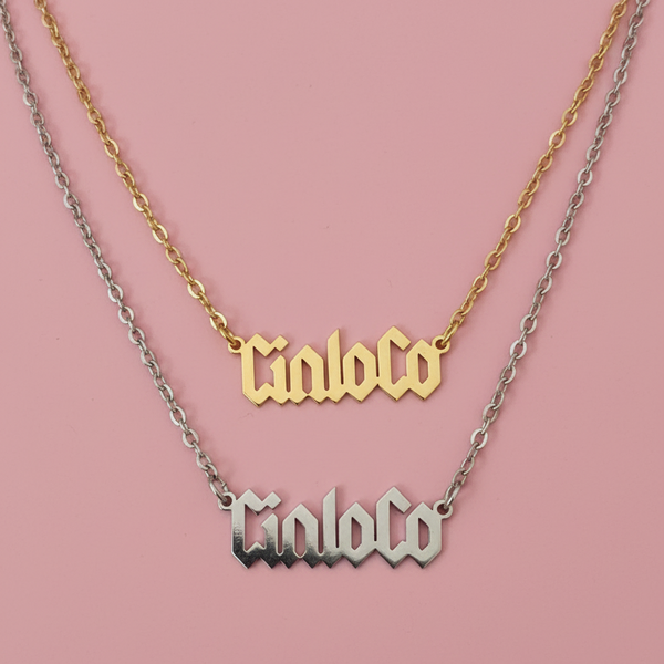 Two necklaces with custom name plate  on a pink background