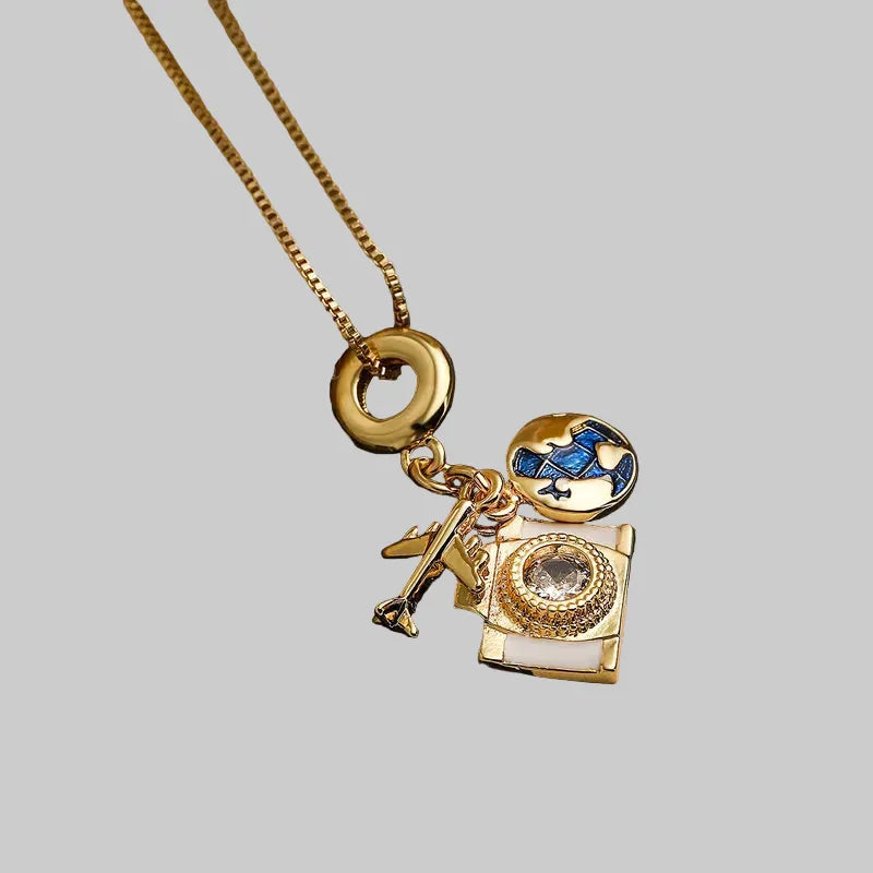 Gold necklace with a decorative pendant on a textured surface
