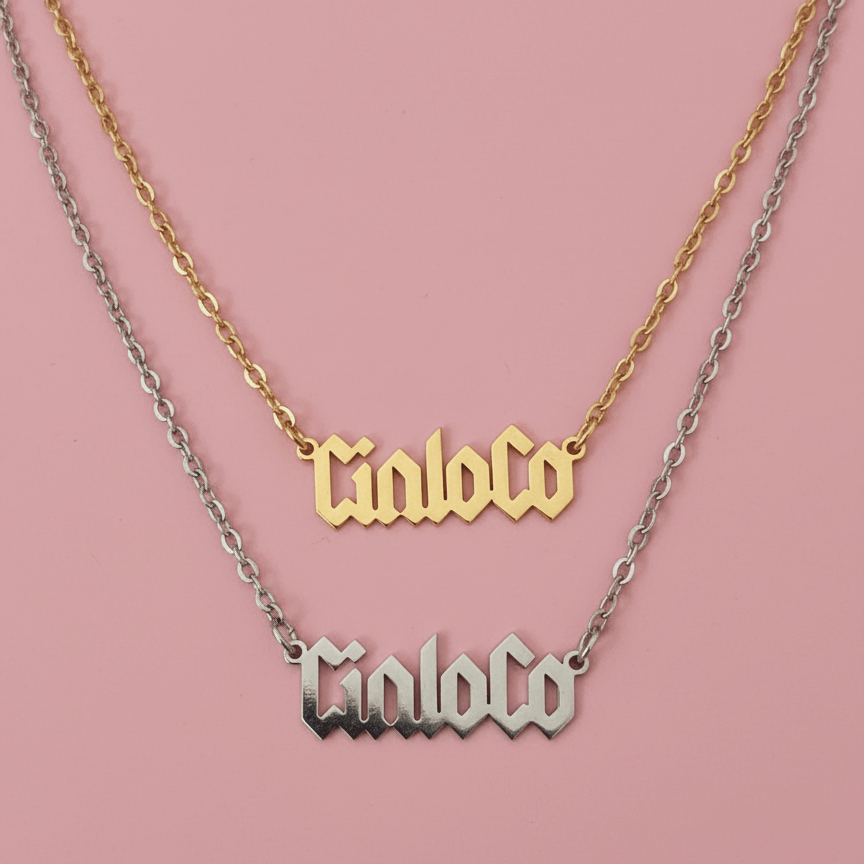 Two necklaces with custom name plate  on a pink background