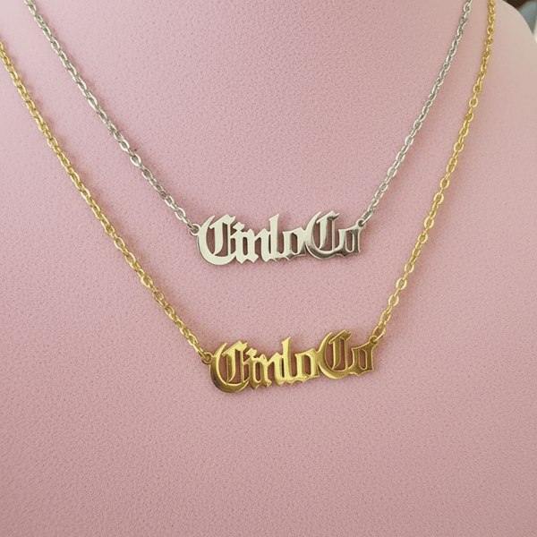 Two necklaces with CUSTOM NAME PLATE pendants on a mannequin.