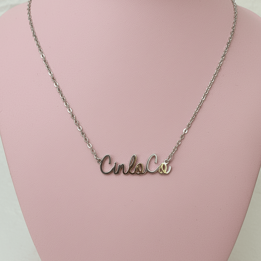 Necklace with silver customizable name plate pendant on a pink mannequin bust.