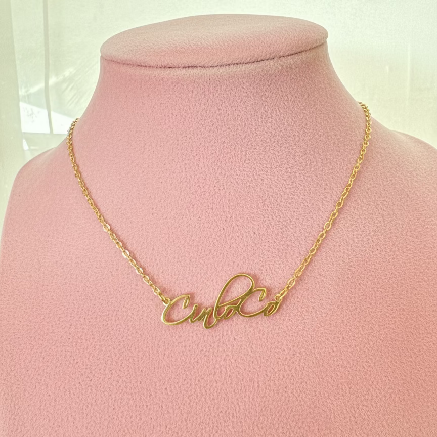 Gold necklace with cursive custom name plate mannequin bust against a light background