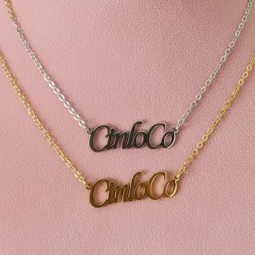 Two gold necklaces with 'Cinlo Co' on a black background
