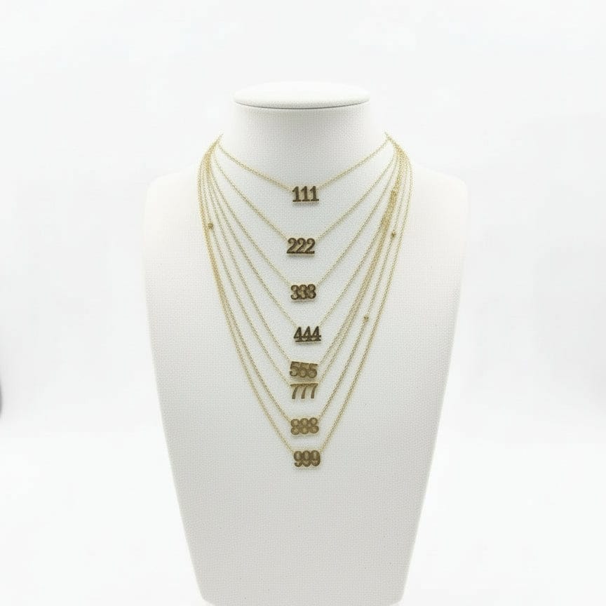 Set of gold necklaces on a white mannequin bust with visible chain lengths.