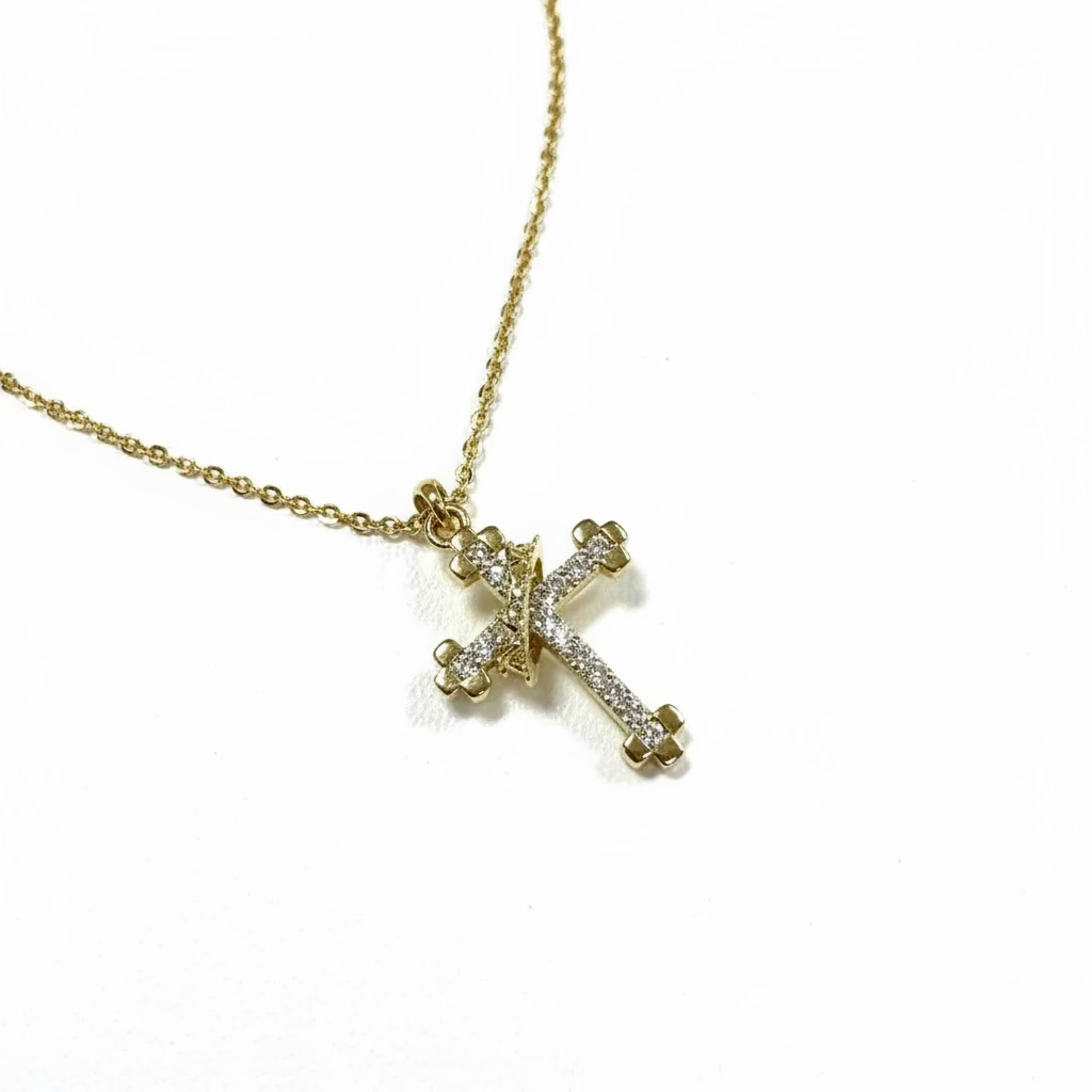 Gold necklace with a cross pendant on a light gray background