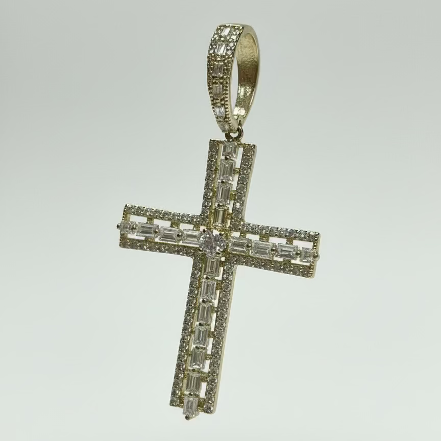 Silver cross pendant with clear stones on a light gray background