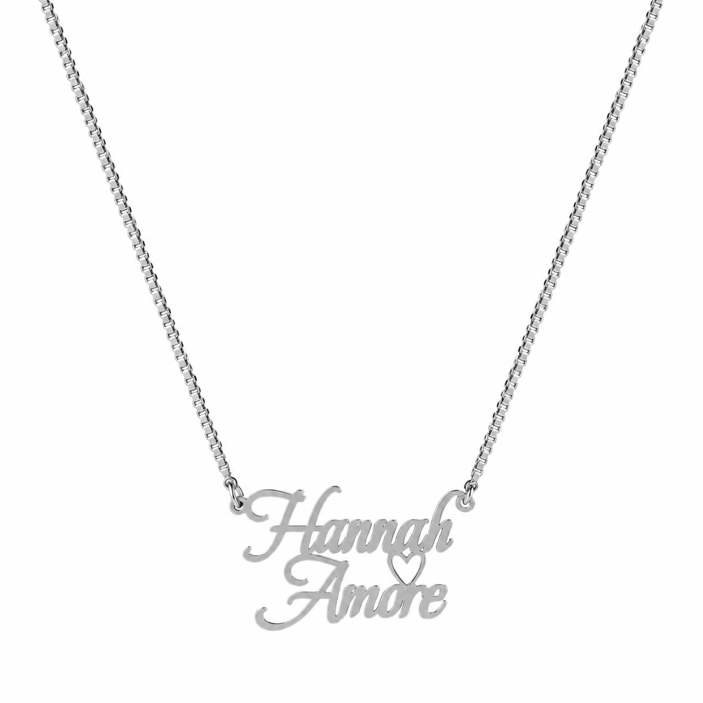 A gold nameplate necklace reading 'Hannah Amore' with a small heart detail, suspended from a gold chain on a plain white background.